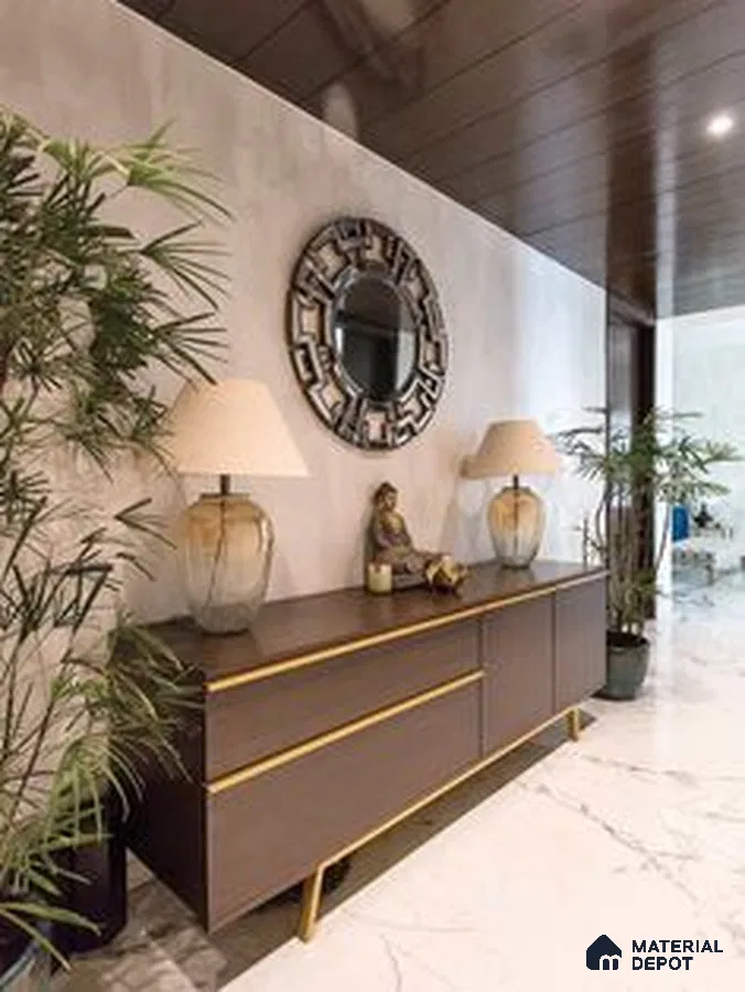 a kitchen with marble counter tops and wooden cabinetry, along with an island in the middle of the middle of the island with stairs leading to shop & more counter top space to an island in the middle of